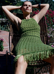 woman waring green knit midi dress with fringe