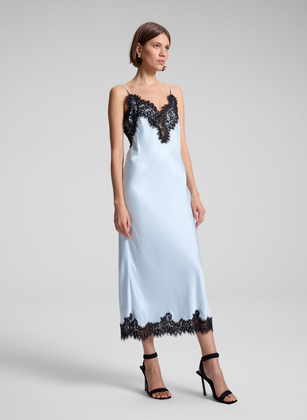 woman wearing blue and black lace slip dress