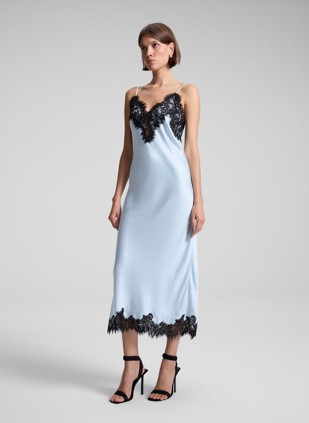 woman wearing blue and black lace slip dress