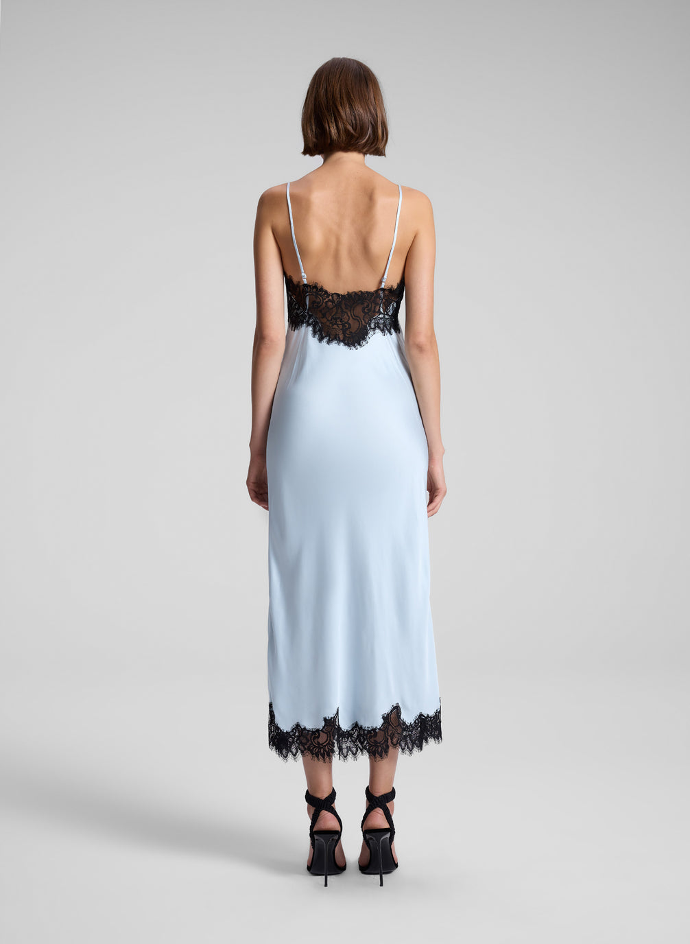 woman wearing blue and black lace slip dress