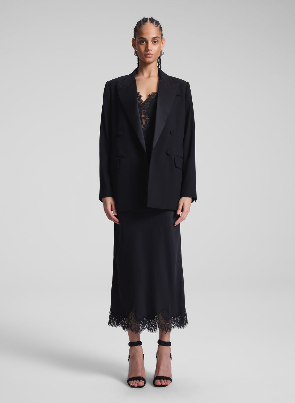 woman wearing black slip dress and jacket