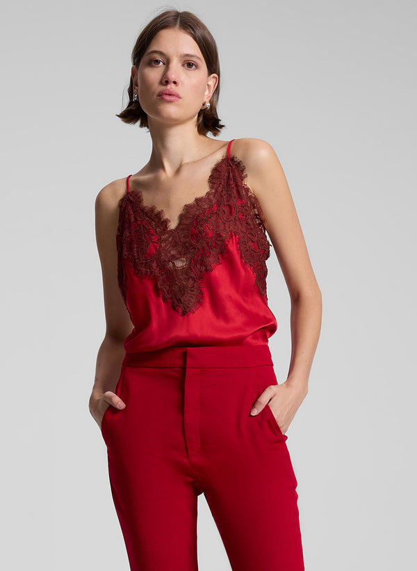 woman wearing red lace camisole and red pants