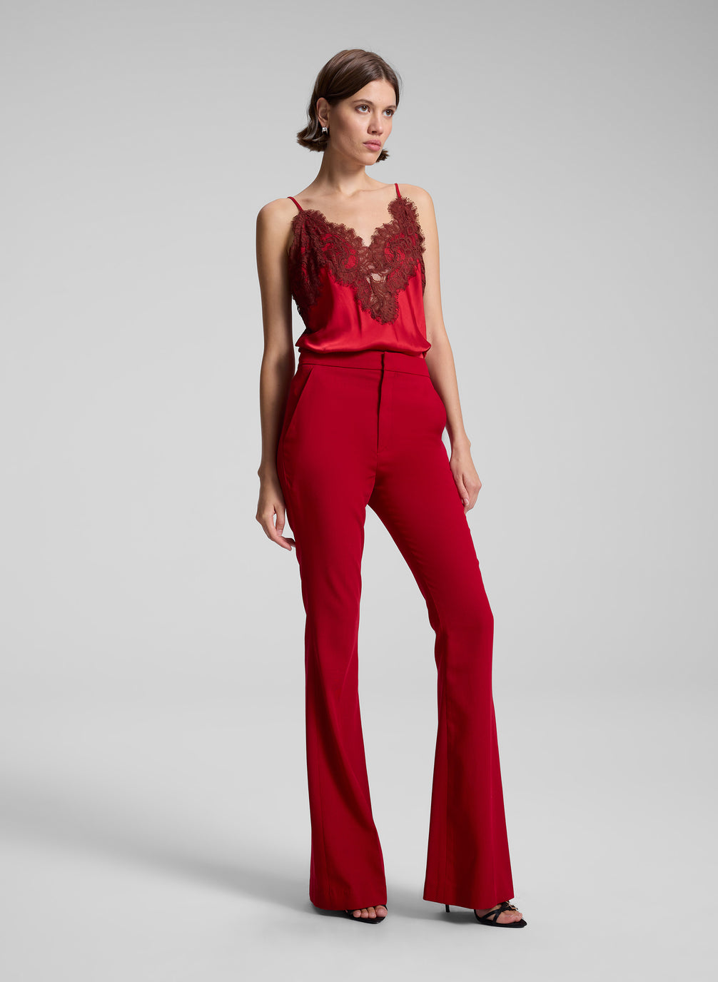 woman wearing red lace camisole and red pants