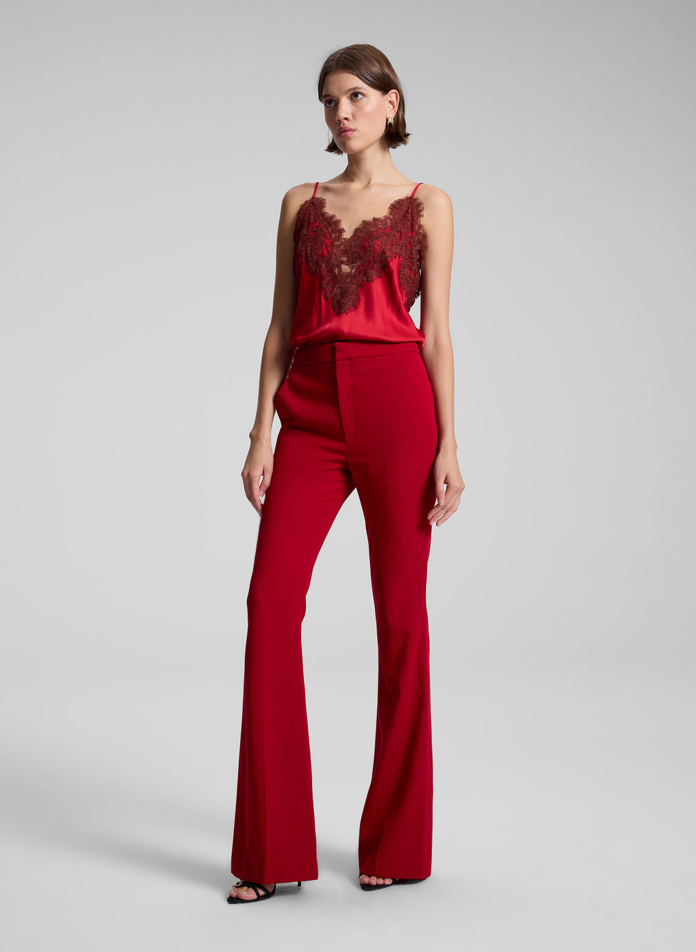 woman wearing red lace camisole and red pants