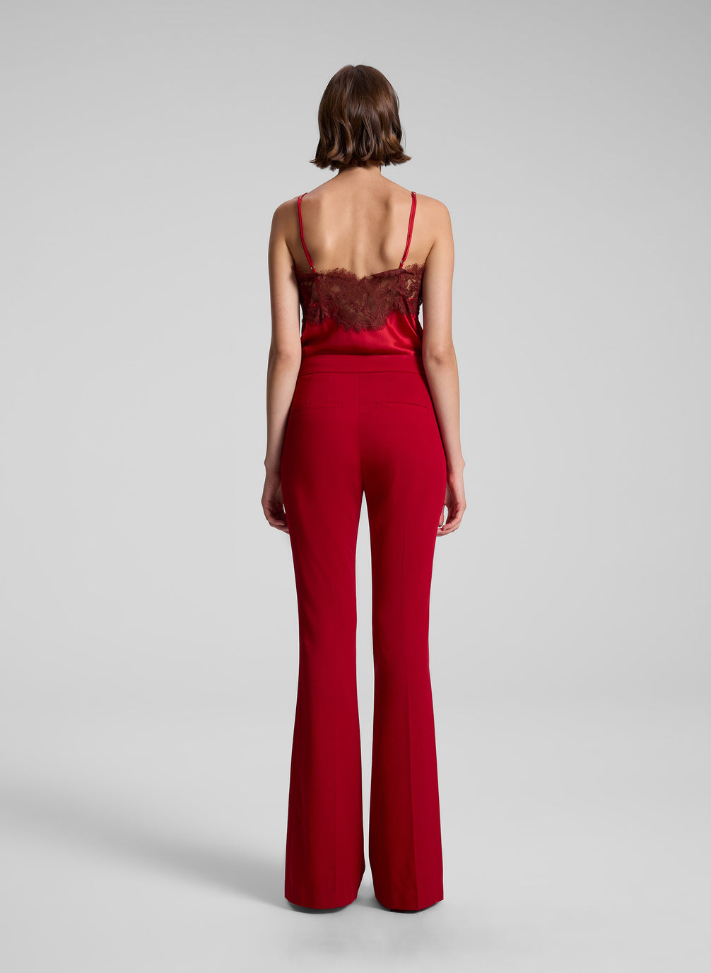 woman wearing red lace camisole and red pants