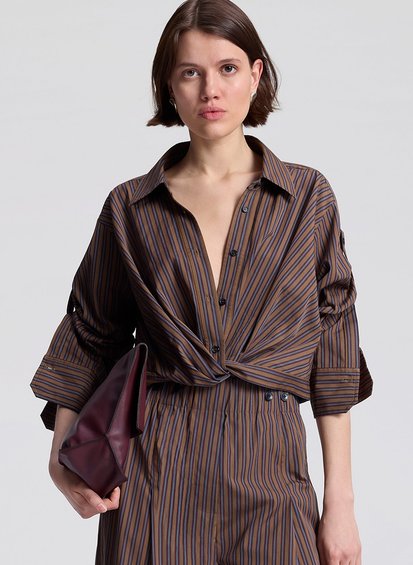 woman wearing brown stiped shirt and matching brown striped pants