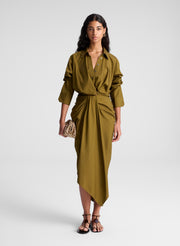 woman wearing olive green shirt and matching draped olive green midi skirt