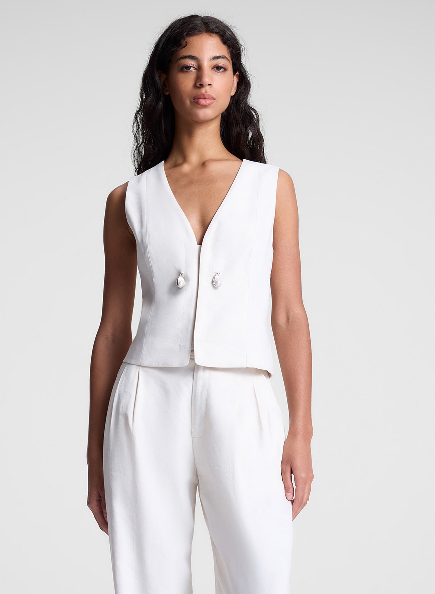 woman wearing cream vest and matching pants