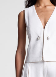 woman wearing cream vest and matching pants