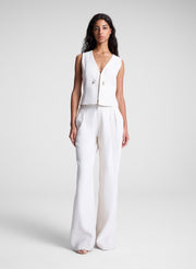 woman wearing beige vest and matching pants