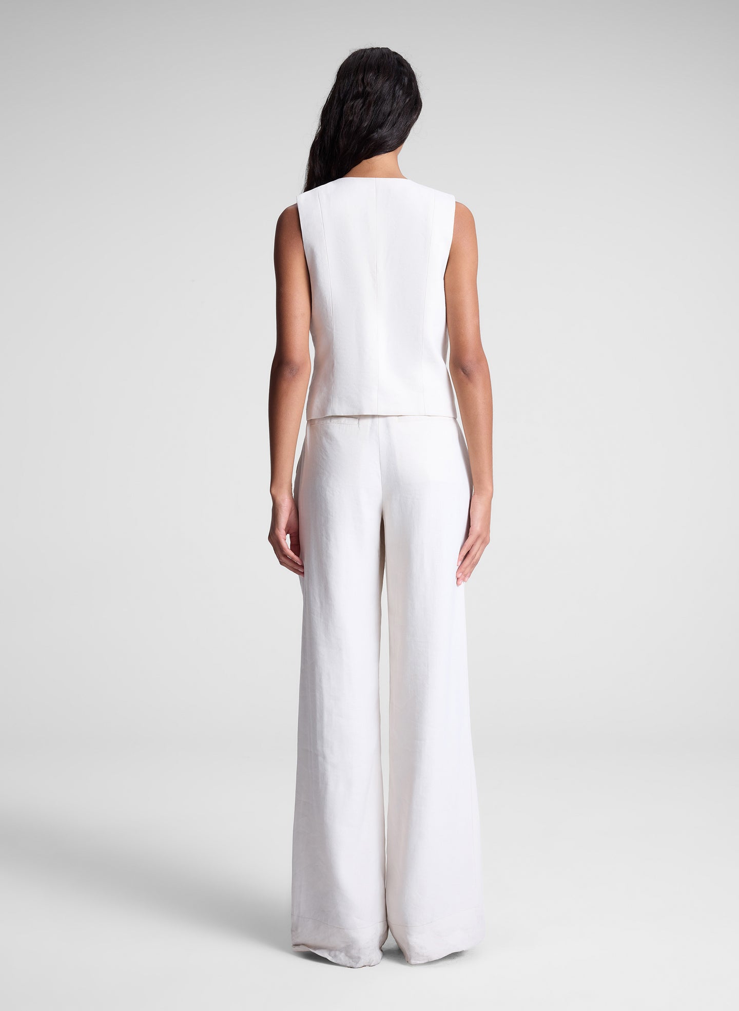 woman wearing cream vest and matching pants