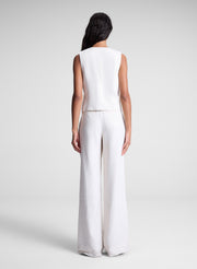 woman wearing beige vest and matching pants