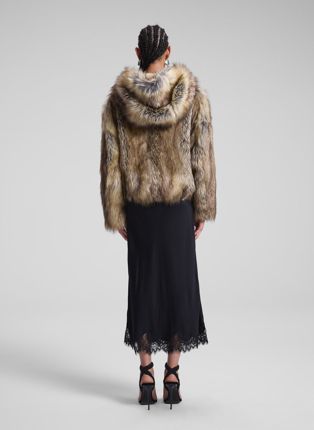 woman wearing faux fur coat and black dress