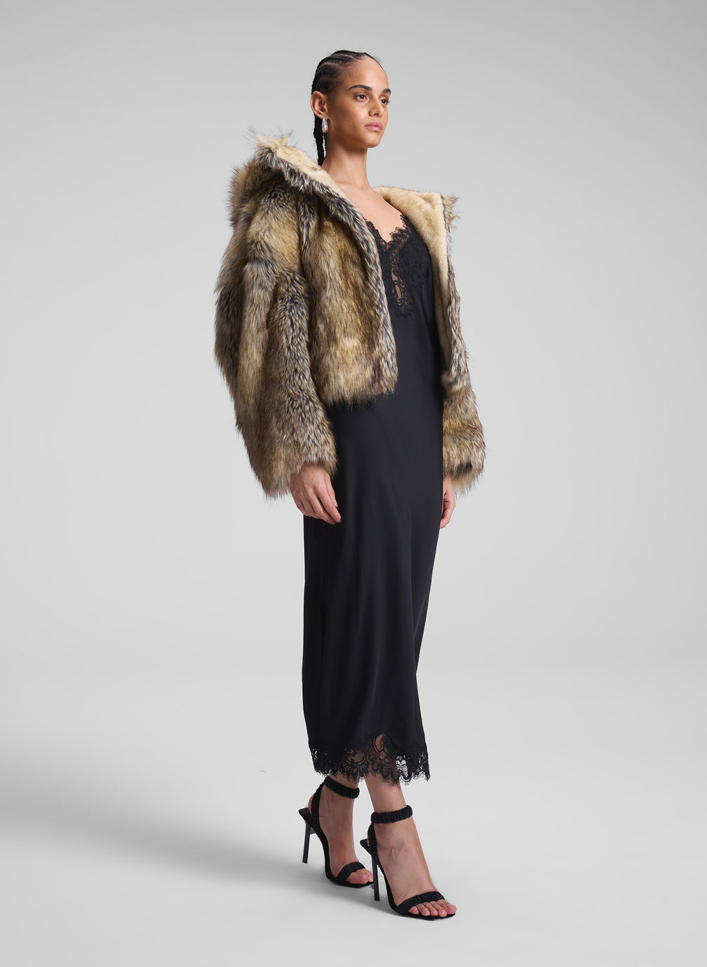 woman wearing faux fur coat and black dress