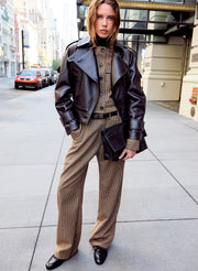 woman wearing leather jacket and checked wool outfit