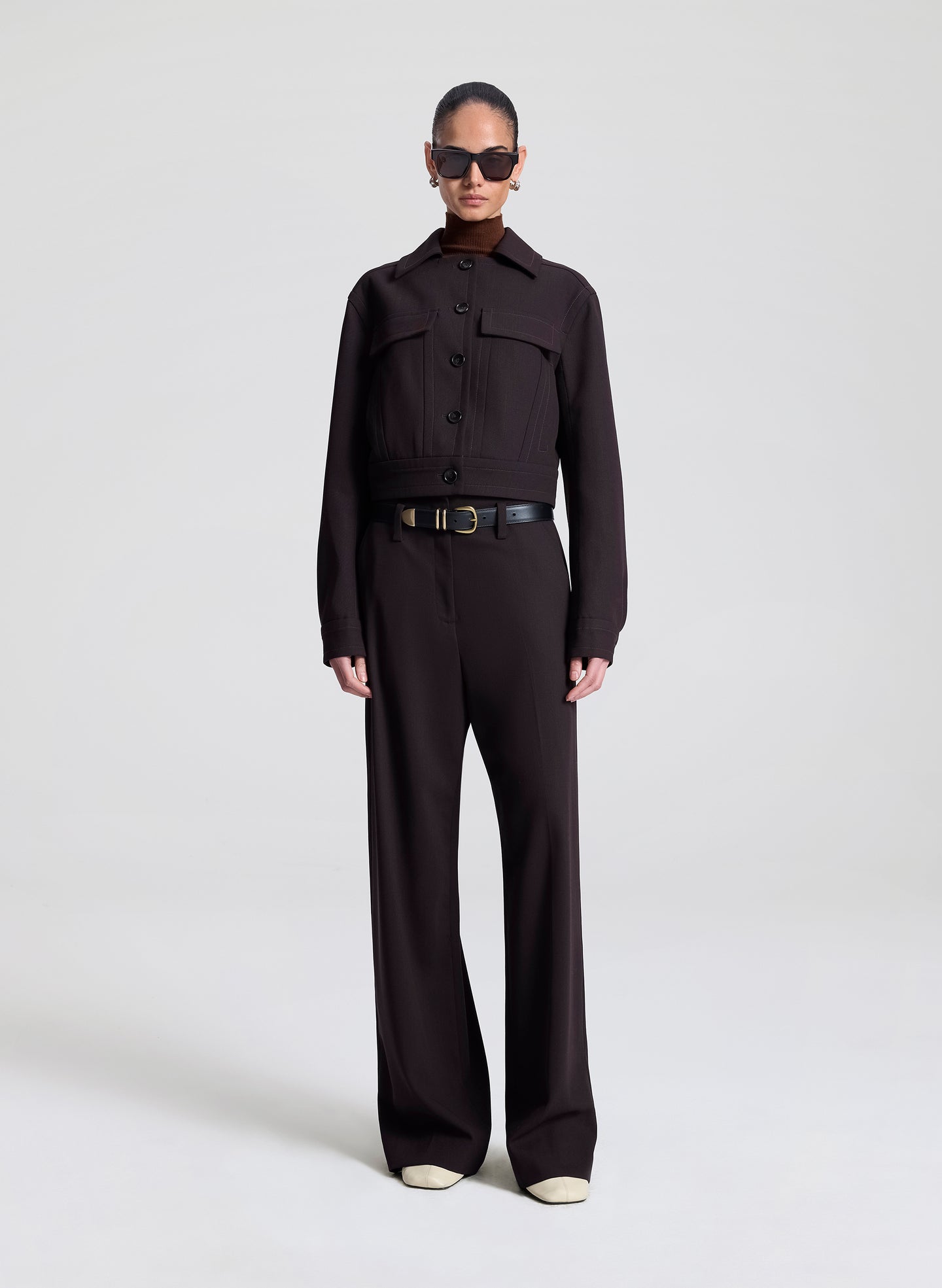 woman wearing dark brown jacket with matching dark brown pants