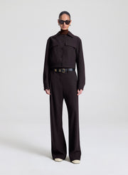 woman wearing dark brown jacket with matching dark brown pants