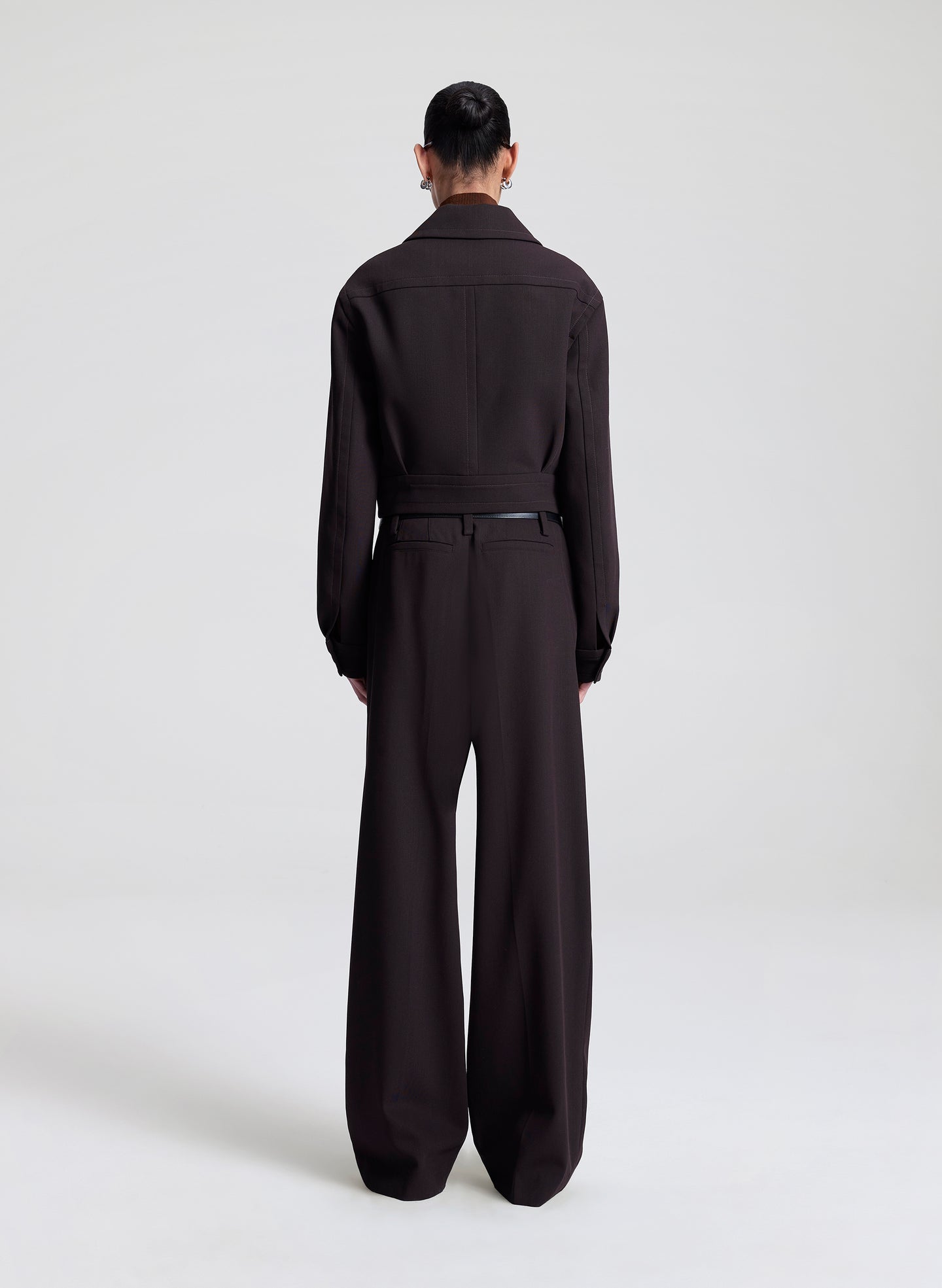 woman wearing dark brown jacket with matching dark brown pants