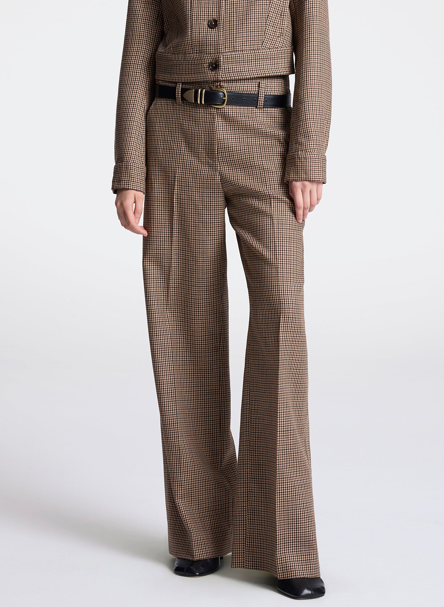 woman wearing  a brown checkered jacket and matching pants  