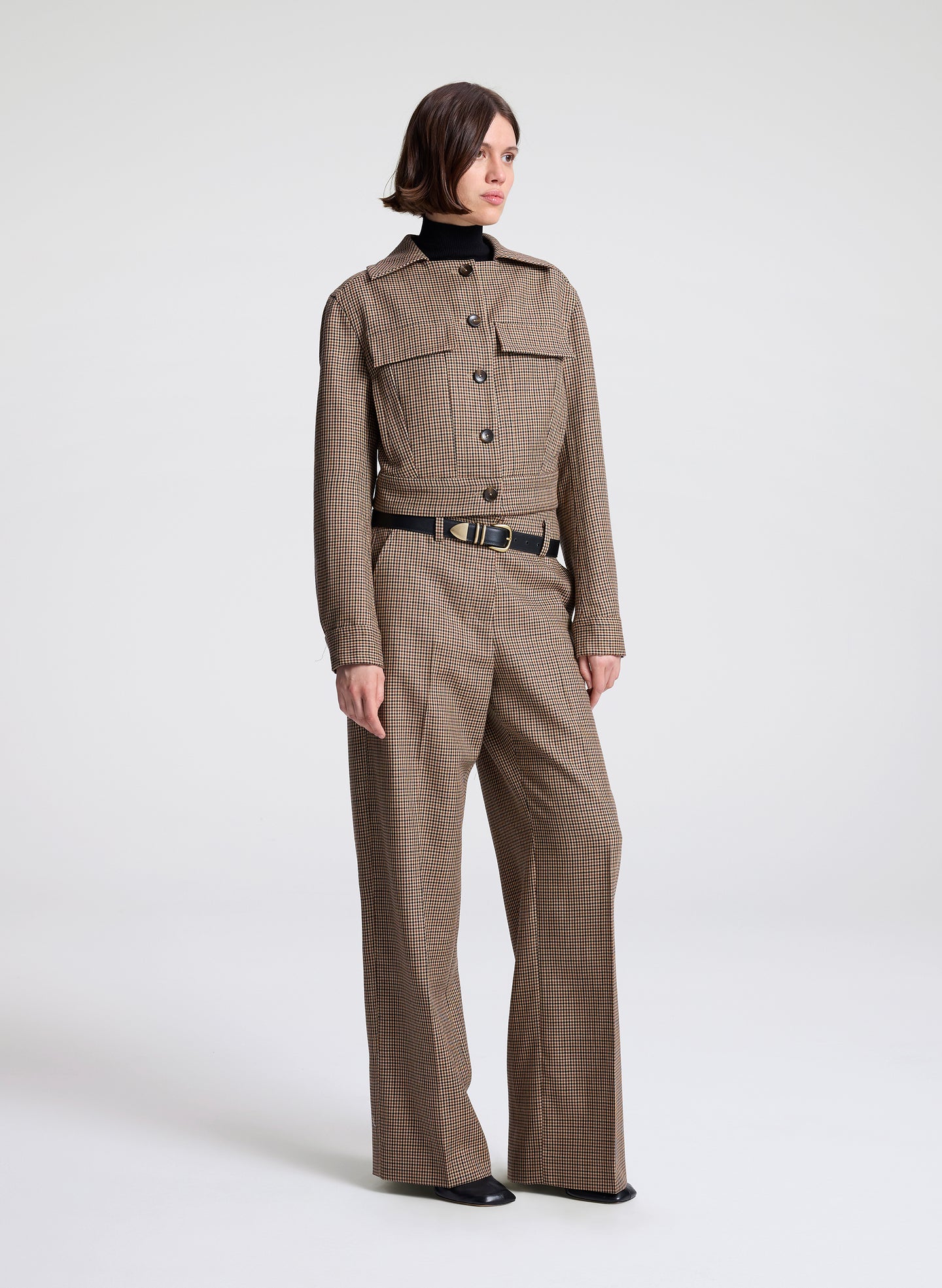 woman wearing  a brown checkered jacket and matching pants  