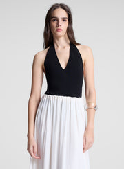 woman wearing black haler bodysuit and white maxi skirt