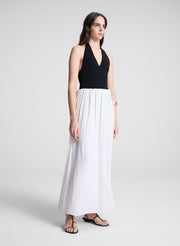 woman wearing black haler bodysuit and white maxi skirt