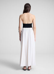 woman wearing black haler bodysuit and white maxi skirt