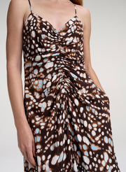 close up of woman in brown print midi dress