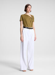 woman wearing green asymmetric tee and beige pants