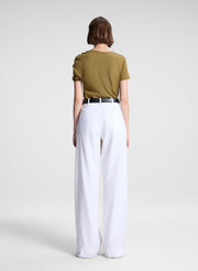 woman wearing green asymmetric tee and beige pants