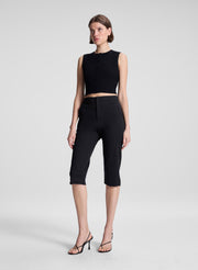 woman wearing black cropped sleeveless fine gauge voile knit top and black capri pants