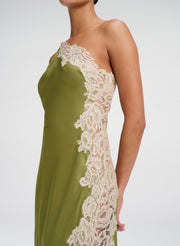 Green midi dress with white lace detailing on a white background