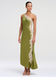 Woman wearing a green one-shoulder dress with lace details on a white background