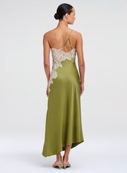 Woman wearing a green midi dress with lace details on a white background