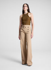 woman wearing brown tank top and tan sailor button pants