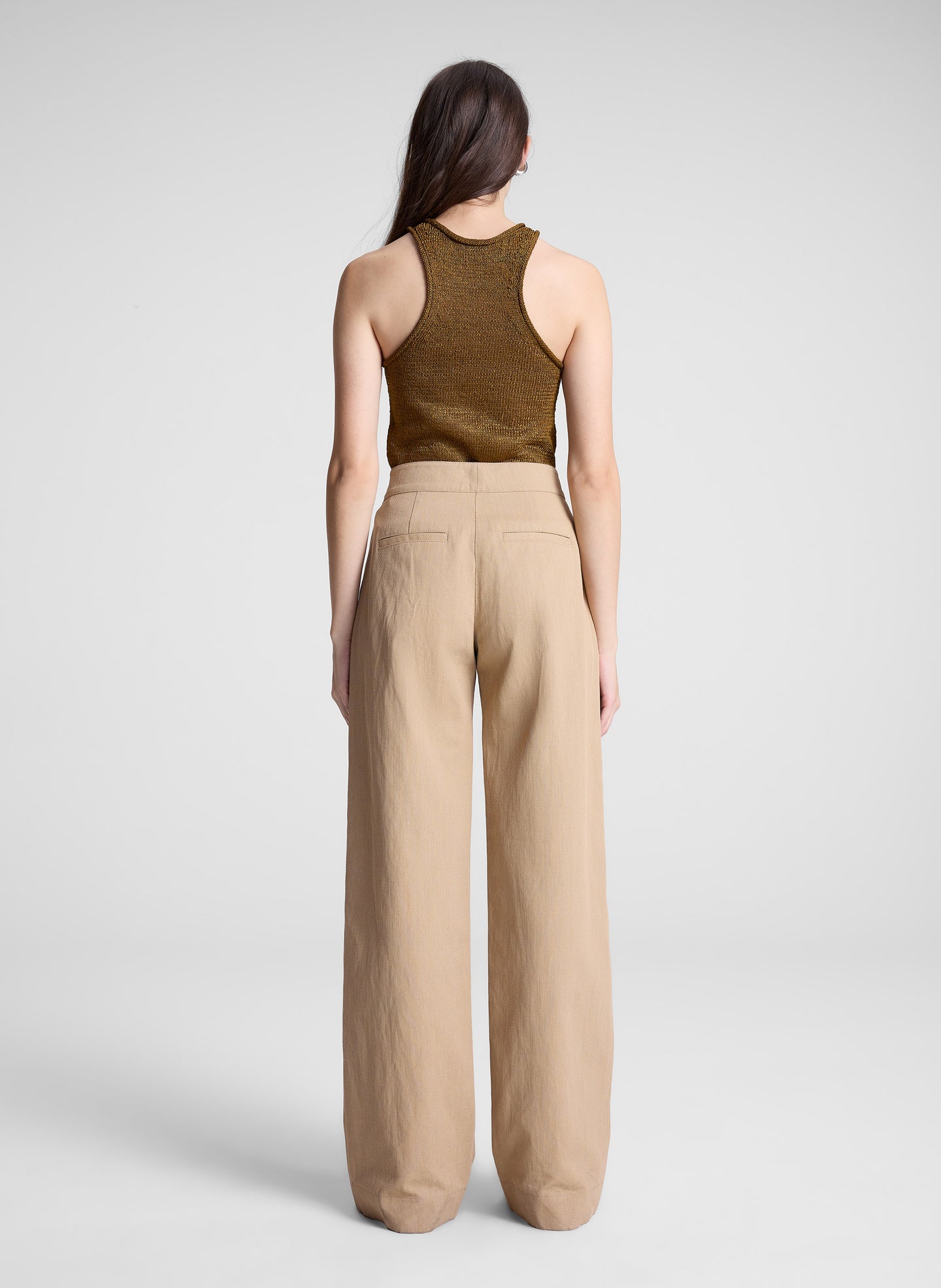 woman wearing brown tank top and tan sailor button pants