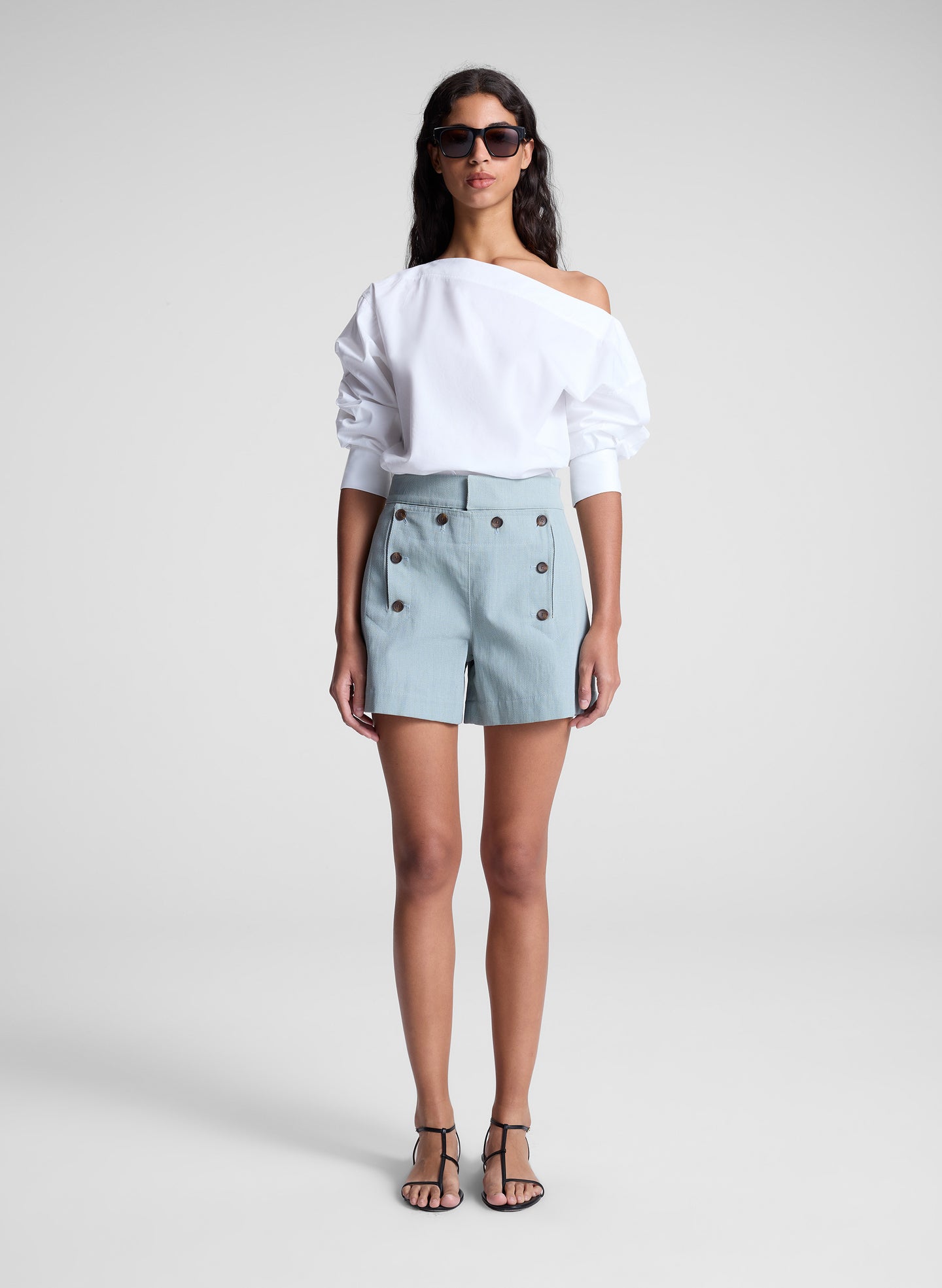 woman wearing white off shoulder top and light blue shorts