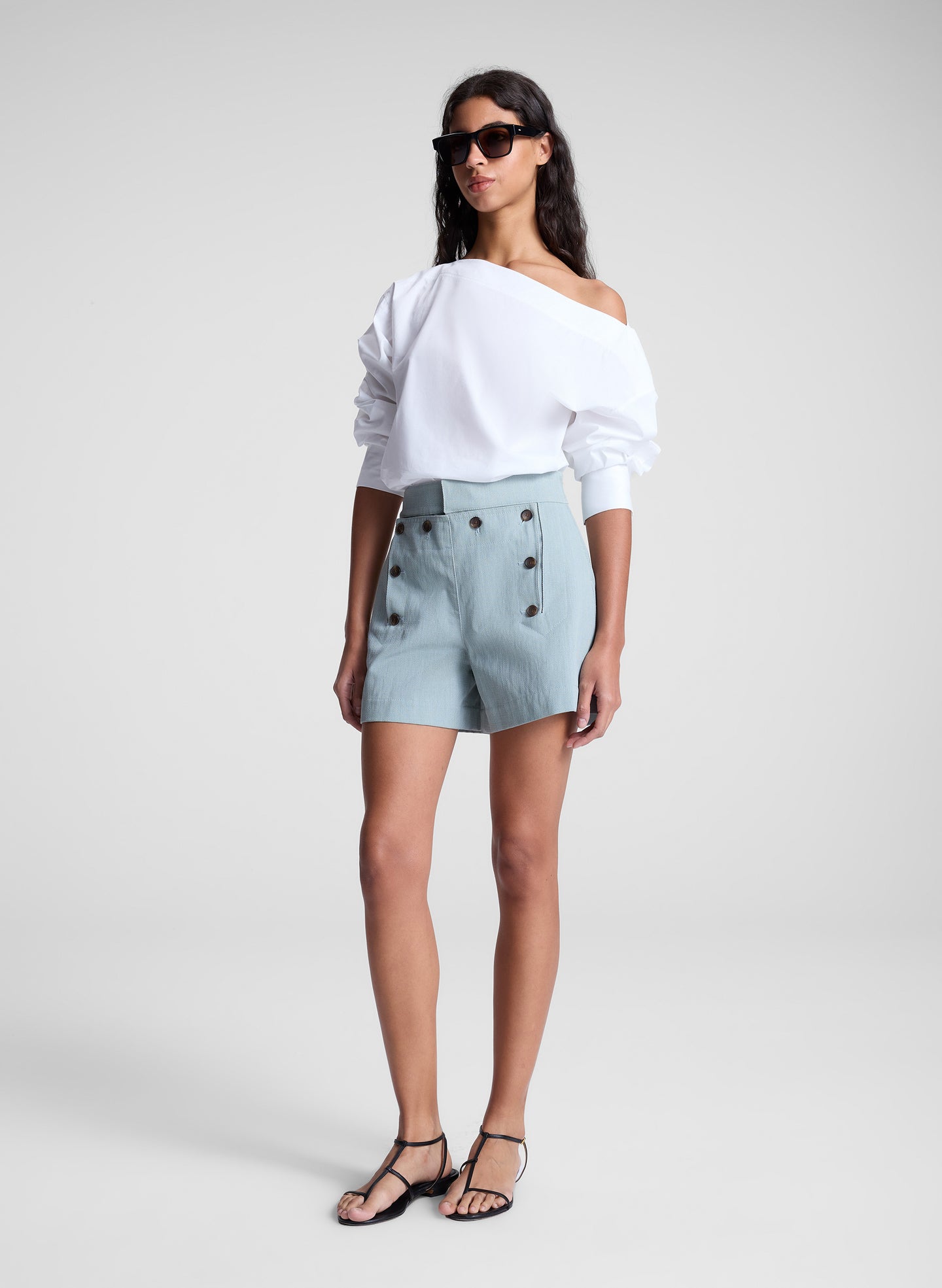 woman wearing white off shoulder top and light blue shorts