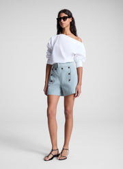 woman wearing white off shoulder top and light blue shorts