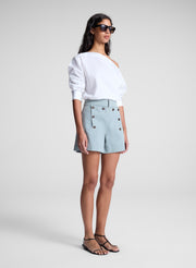 woman wearing white off shoulder top and light blue shorts