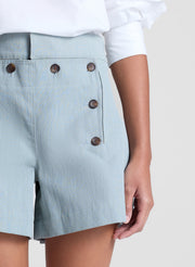 woman wearing white off shoulder top and light blue shorts