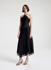 woman wearing black satin and lace midi dress