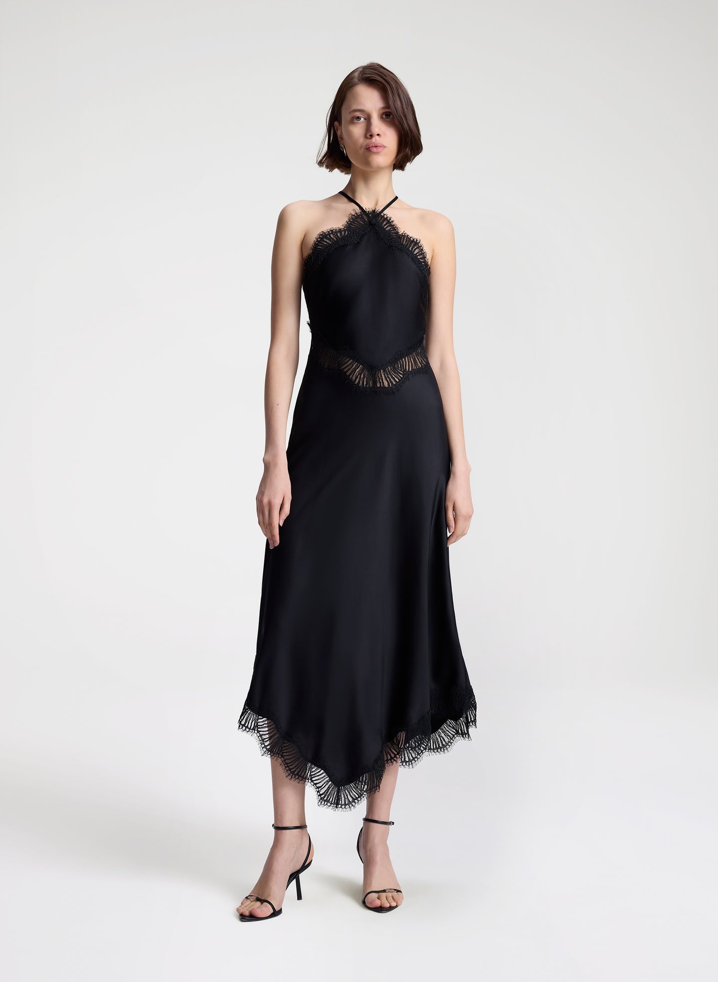 woman wearing black satin and lace midi dress