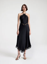 woman wearing black satin and lace midi dress
