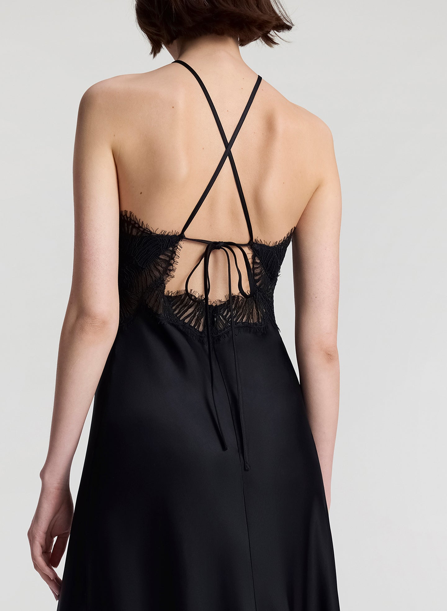 woman wearing black satin and lace midi dress