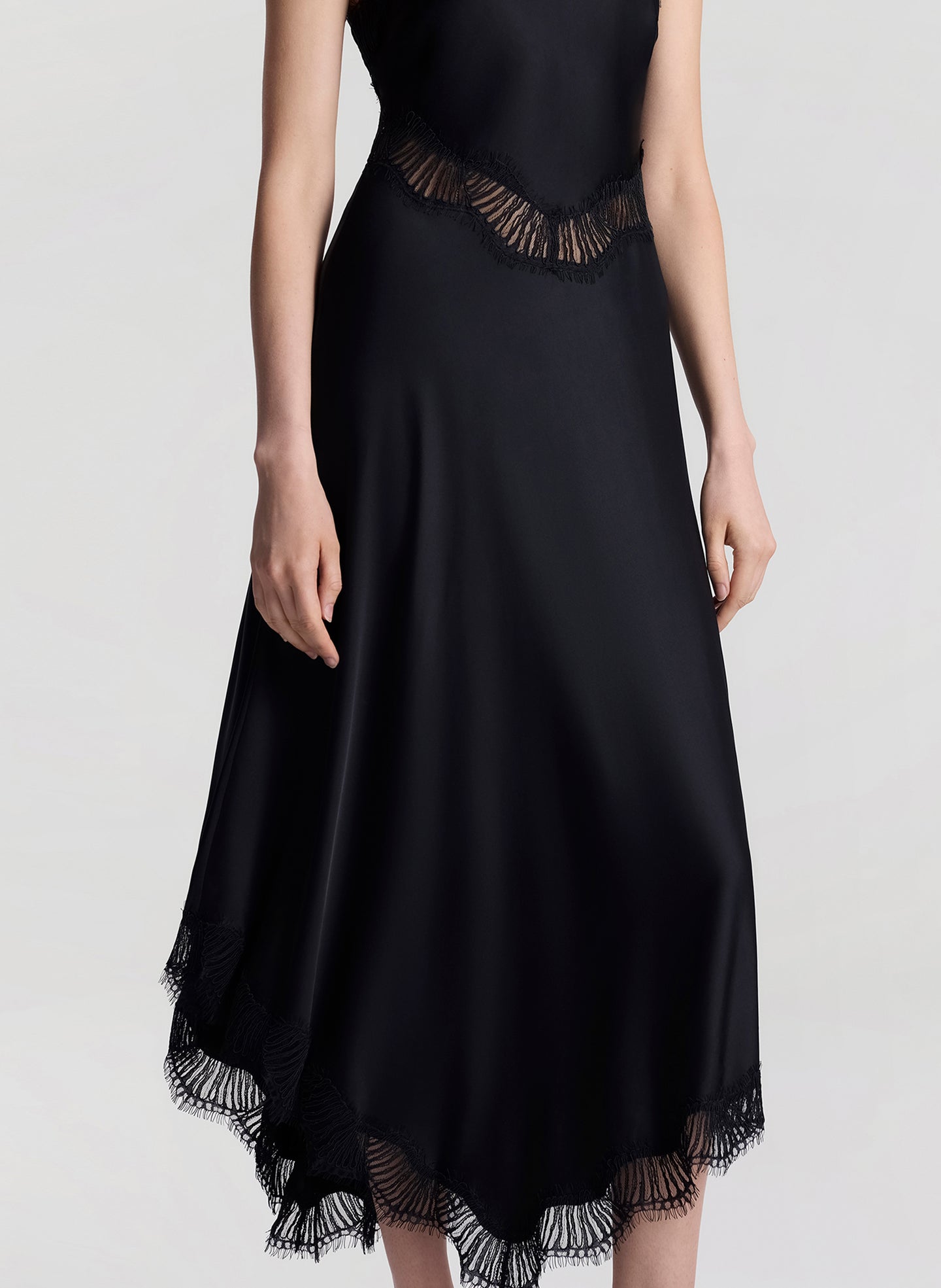 woman wearing black satin and lace midi dress