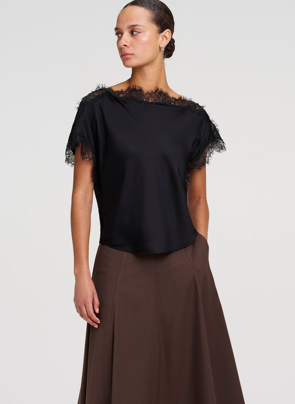 woman wearing black satin and lace top with brown midi skirt