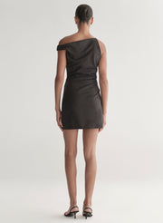 Woman wearing a dark grey one-shoulder mini dress on a white background