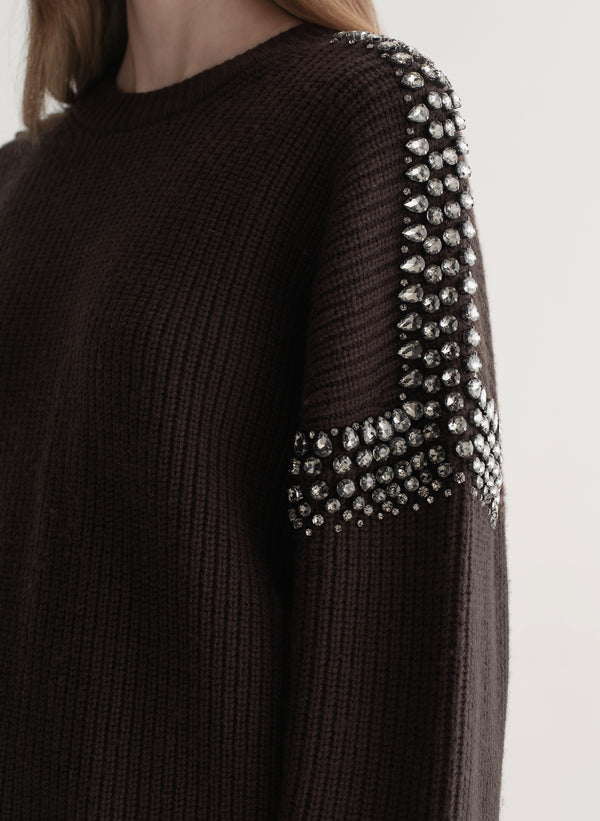 woman wearing brown embellished sweater with black denim jeans