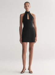 Black halter neck dress worn by a model on a white background